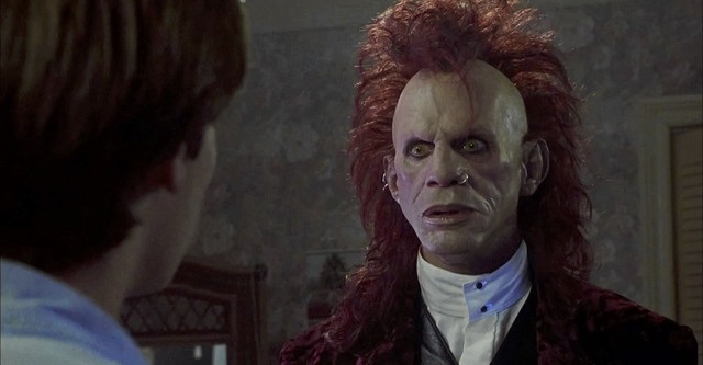 the Trickster, with a nose piercing and red glam-metal hair