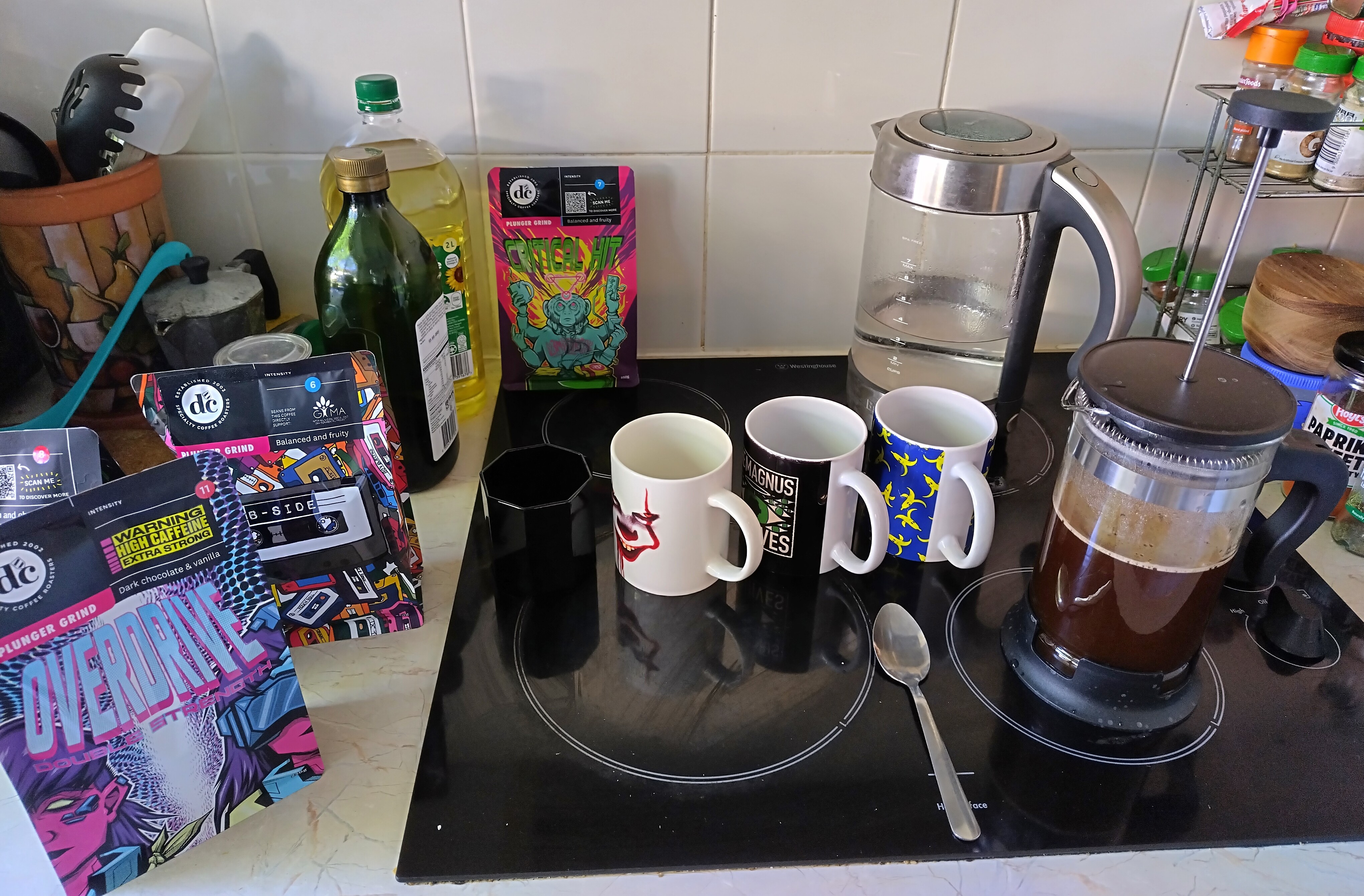image of coffee implements and beans... spoon, press, many mugs, on my dirty stove
