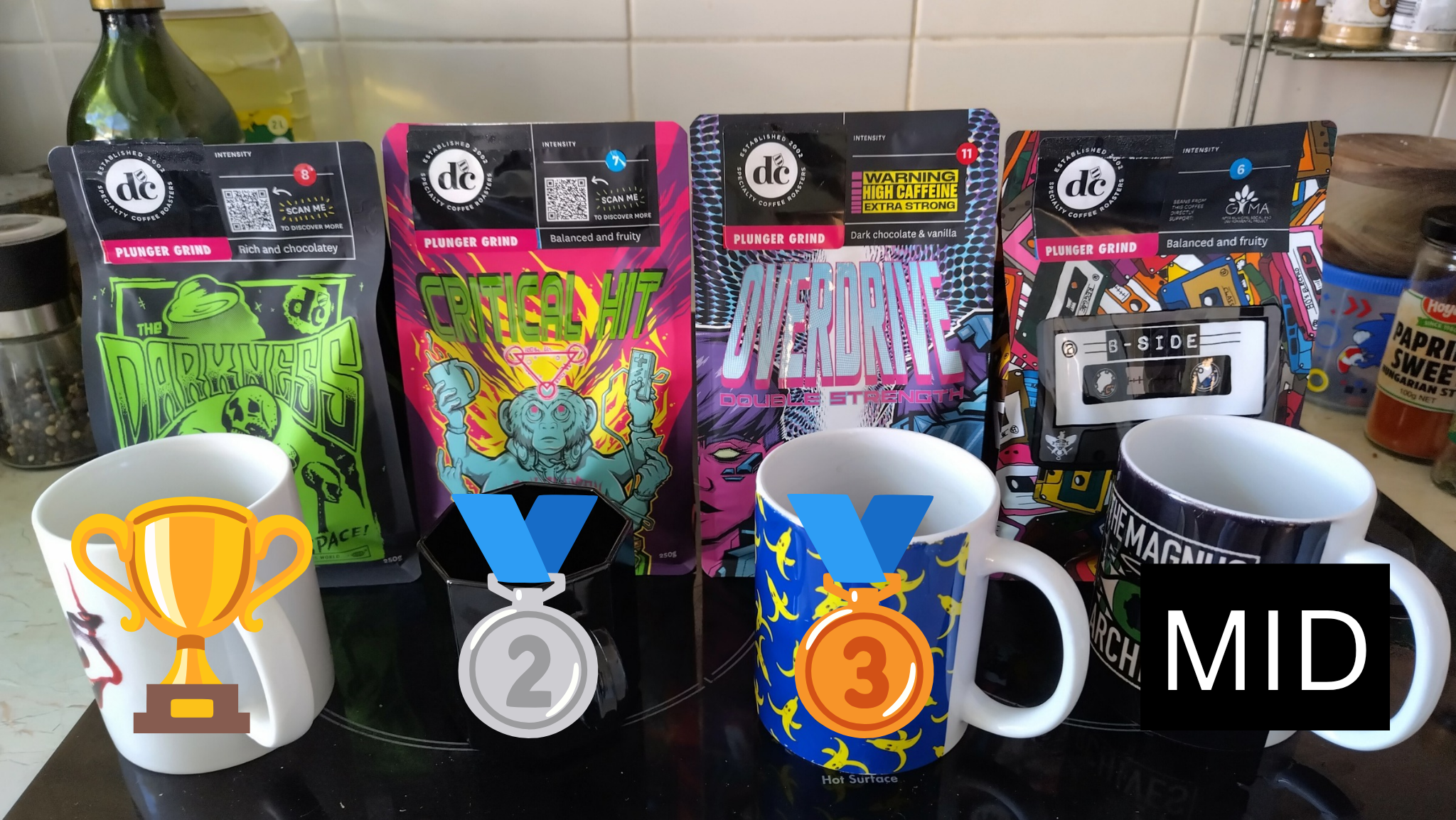 four bags of coffee with first, second, and third place, along with the final one labelled 'mid'
