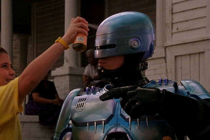 shot of a kid spray painting on robocop's head (from hello dankness)